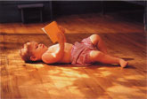 Baby lying on heated hardwood floor.